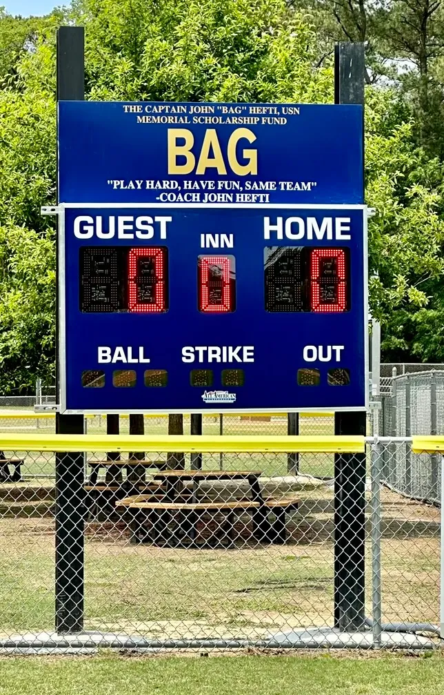 Bag's Buddies scoreboard with Coach John Hefti's Play Hard, Have Fun, Same Team quote